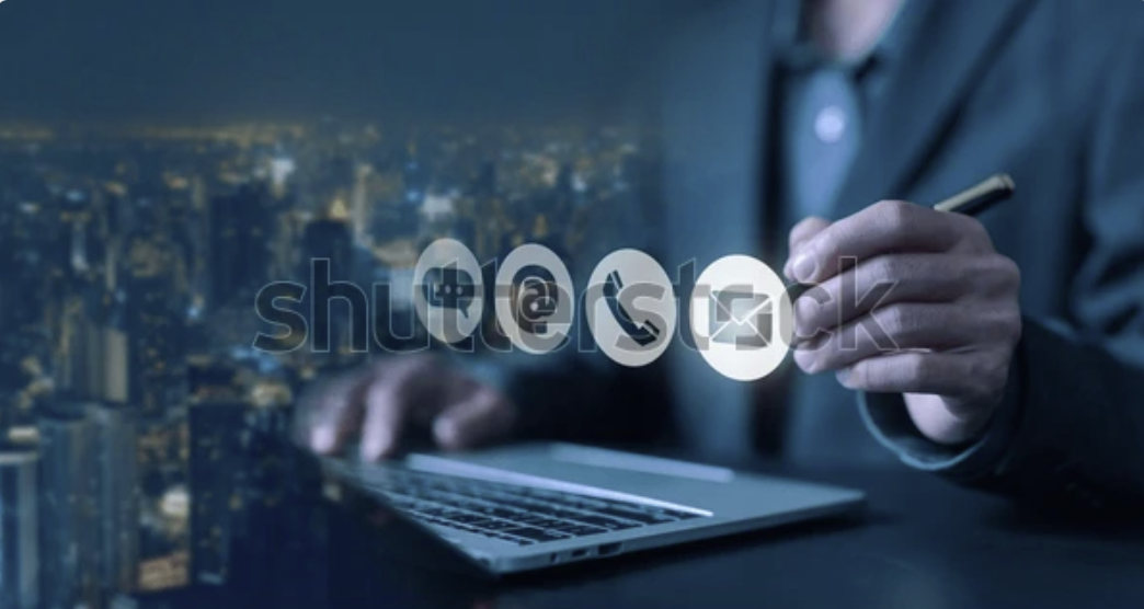 A person interacting with contact icons overlaid on a city skyline, symbolizing modern business communication.